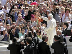 Pope Benedict XVI Joseph Ratzinger between crowds and photographers in the papamobile, 1st audience