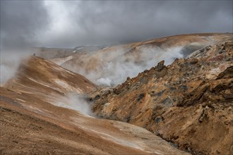 Steaming stream between colourful rhyolite mountains, Hveradalir geothermal area, Kerlingarfjöll,