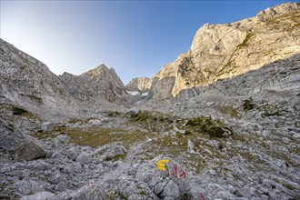 Rocky mountain peaks Blaueisspitze and Hochkalter at sunrise, hiking trail with markings, mountain