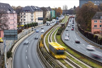 Motorway A40, Ruhrschnellweg, skyline of the city centre of Essen, exit Essen-Huttrop, track bus