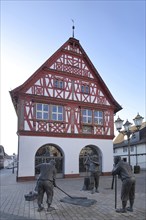 Sculptures and statues in front of the town hall in Groß-Gerau, half-timbered house, figures,