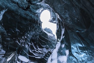 Ice cave open to the top with snow-covered ice combs, Pröng ice cave, Sudurland, Iceland, Europe