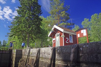 Small red wooden house in a lock, idyll, lockkeeper's house, Dalsland Canal, Sweden, Europe