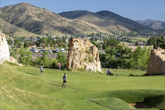 Golden, Colorado, The Fossil Trace Golf Course. Golfers play near footprints of dinosaurs and