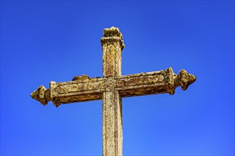 Old baroque crucifix deteriorated by time in Lavras Novas, Minas Gerais, Brasil