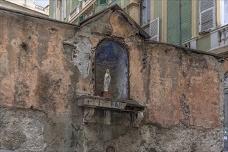 Figure of the Virgin Mary in a niche in a wall of an empty temple, 15th century, historic centre,