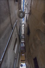 Tall residential buildings in a narrow alley in the historic city centre, Genoa, Italy, Europe