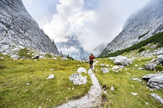 Mountaineer on a hiking trail, cloudy mountains, descent over the Ofental, mountain tour on the