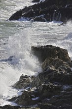 Waves crashing onto rocks along the Normandy coast, France, Europe