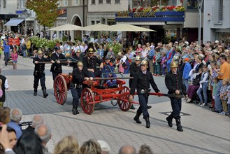 Historical firemen in uniform with an engine parading at Zwetschgenfest, plum festival, Bühl,