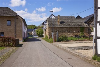 Street with residential buildings, sandstone buildings and half-timbered houses in the district of