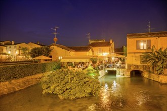 Night shot of a pub on the Mincio River, Valeggio sul Mincio, Province of Verona, Italy, Europe