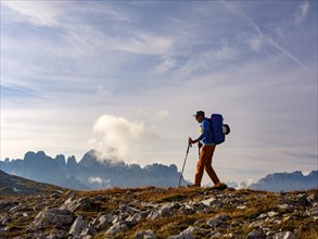 Mountaineer on the Dolomites High Route 8, behind rose garden, Schlern, Dolomites, South Tyrol,