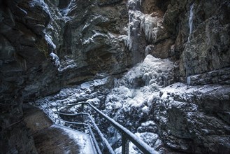 Winter, snowy landscape, frozen waterfall, hiking trail through the Breitachklamm gorge near