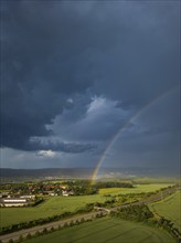 Thunderstorm cell with rainbow over fields near Krebs in the Osterzgebirge, Krebs, Saxony, Germany,