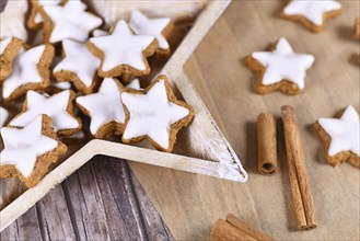 German star shaped glazed Christmas cinnamon cookies called 'Zimtsterne' made with almonds, egg