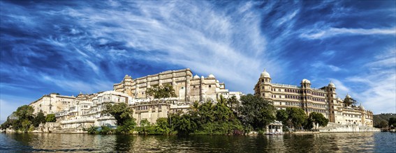 India luxury tourism concept background, panorama of Udaipur City Palace from Lake Pichola.