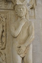 Adam with a fig leaf on the western gate of Trogir Cathedral or Cathedral of St. Lawrence, 13th