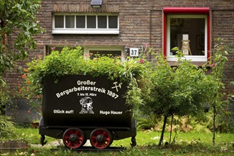 Coal lorry in the front garden commemorating the big miners' strike in 1997, Gelsenkirchen, Ruhr