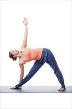 Beautiful sporty fit yogini woman practices yoga asana utthita trikonasana, extended triangle pose