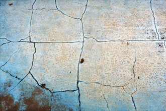 Dirty broken floor in a swimming pool, cracks, peeling paint, dilapidated swimming pool, lost