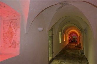 Colourfully illuminated cloister in the Carthusian monastery of Allerengelberg, Schnalstal Valley,