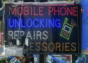 Neon electric sign for Mobile Phone Unlocking Repairs Accessories, Deptford High Street, London