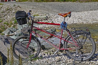 Well-used bicycle (biobike) standing by a stream, Kennecott, Wrangell-St. Elias National Park,