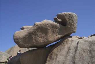 Tourists visiting strange rock formations due to wind and water erosion along the Côte de granit