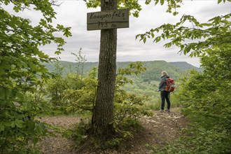 Woman with rucksack at the Knaupenfels viewpoint, Swabian Alb, Baden-Württemberg, Germany, Europe