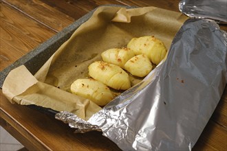 Process of baking whole half slices potato in oven