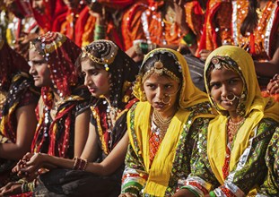 PUSHKAR, INDIA, NOVEMBER 21, 2012: Unidentified Rajasthani girls in traditional outfits prepare for