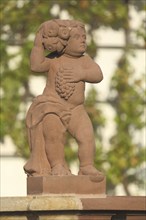 Red stone putto with grapes, detail, monastery complex, Seligenstadt, Main, Hesse, Germany, Europe