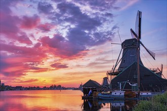 Netherlands rural scene, - windmills at famous tourist site Zaanse Schans in Holland on sunset with