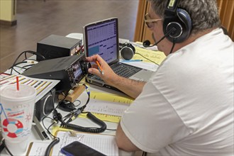 Bosque Farms, New Mexico, John Schaaf, an amateur radio operator, participates in the American