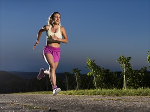 Young woman in Fitness training, vineyard at Grossheppach, Remstal valley, Baden Württemberg,