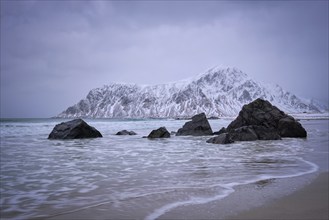 Waves on coast of Norwegian sea in fjord. Skagsanden beach, Flakstad, Lofoten islands, Norway. Long