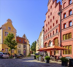 Street scene and historic building fabric with Gothic stepped gables and Baroque volute gables,