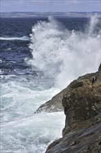 Waves crashing into rocks of cliff along the Brittany coast, France, Europe