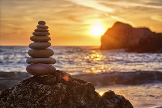 Concept of balance and harmony. Cairn stack of stones pebbles cairn on the beach coast of the sea