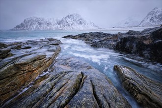 Waves and rocks on coast of Norwegian sea in fjord. Skagsanden beach, Flakstad, Lofoten islands,