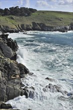 Waves crashing on the rocks of sea cliff at the Pointe du Millier at Beuzec-Cap-Sizun, Finistère,