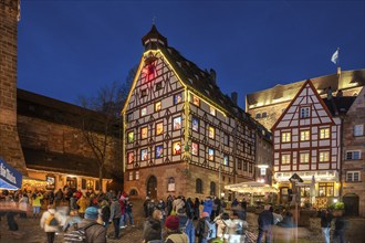 Historic Pilkatushaus with an Advent calendar on 18 December 2024 at dusk, behind the Imperial