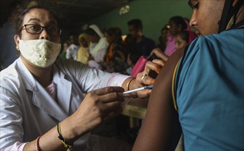 Beneficiaries receives dose of COVID-19 coronavirus vaccine in a vaccination centre at a village in