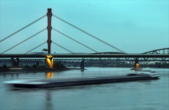 A ship on the Rhine, in the background the motorway bridge of the A42 crossing the Rhine in