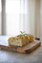 Georgian cheese pie Achma cut on pieces on a table