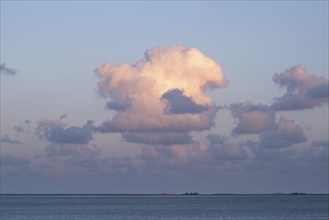 Clouds in the evening light over the North Sea, in the background the Halligen, Wyk, Föhr, North