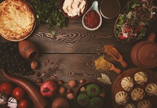 Traditional Georgian table, top view, Khinkali, Phali, Shoti, Khachapuri, Sauces, Fruits, nuts,