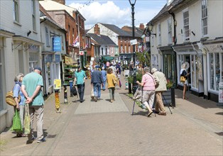 People shopping in pedestrianised street, The Thouroughfare, Halesworth, Suffolk, England, UK