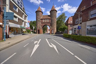 Historic city gate Lüdinghauser Tor against blue sky with cumulus clouds and Lüdinghauser Strasse